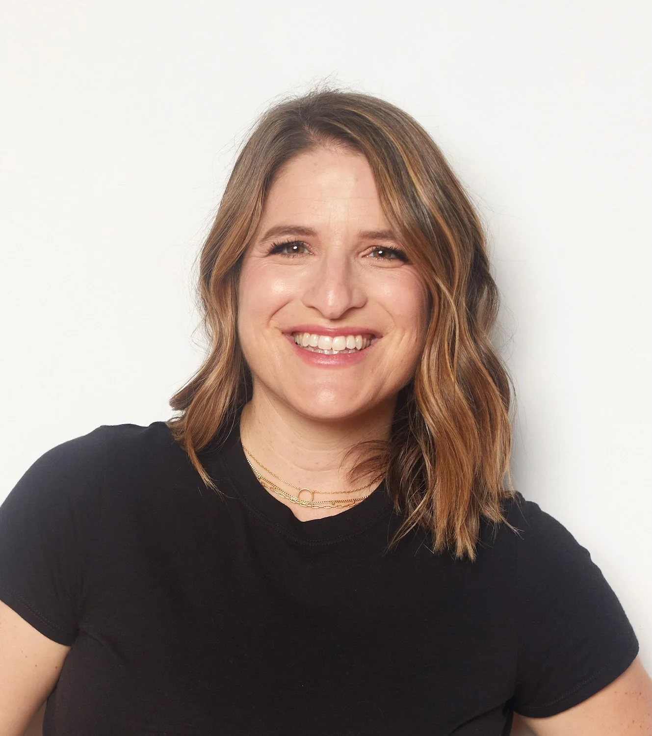 Stacy Berger, smiling in a black t-shirt