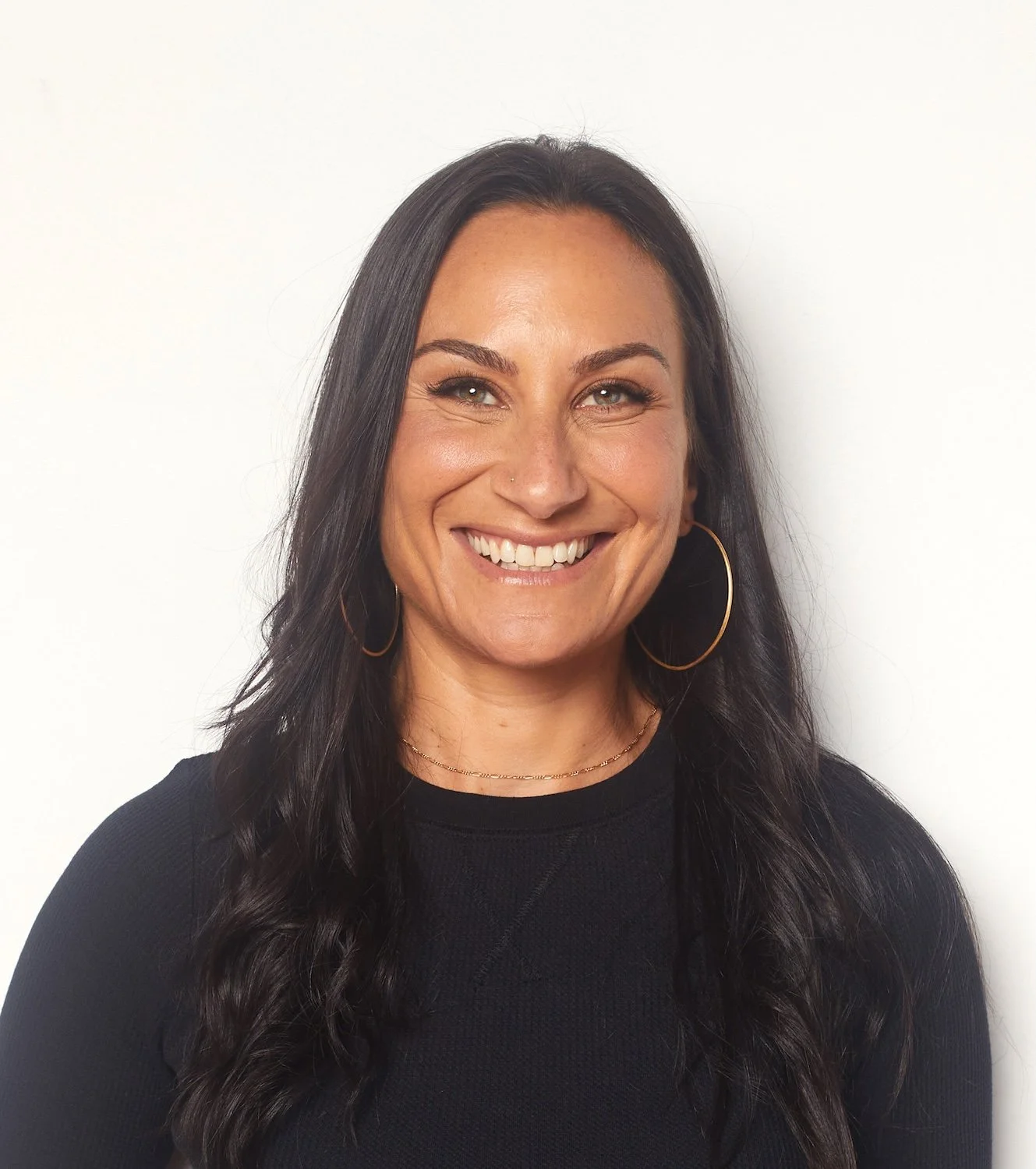 Jenna Shapiro, smiling in a black t-shirt
