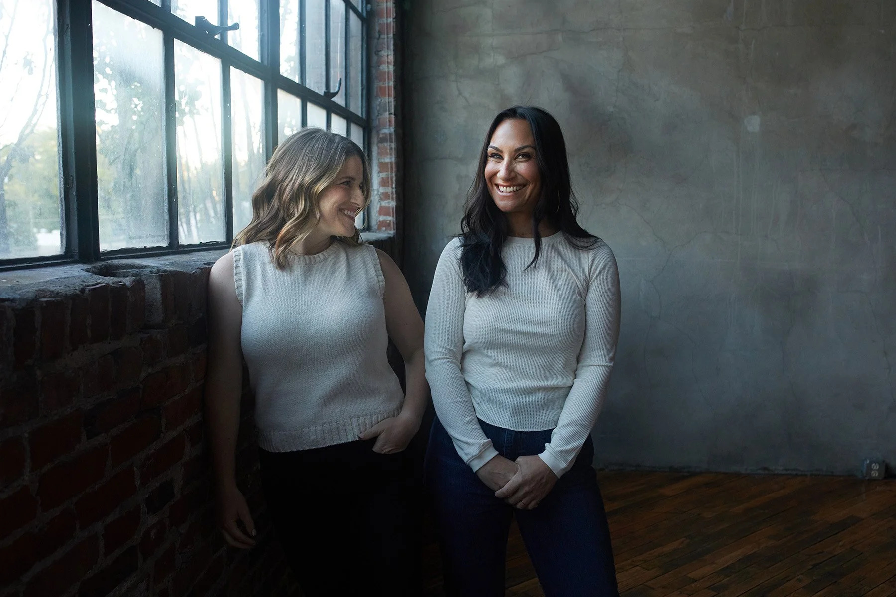 Jenna Shapiro and Stacy Berger of Work Better Together by a window